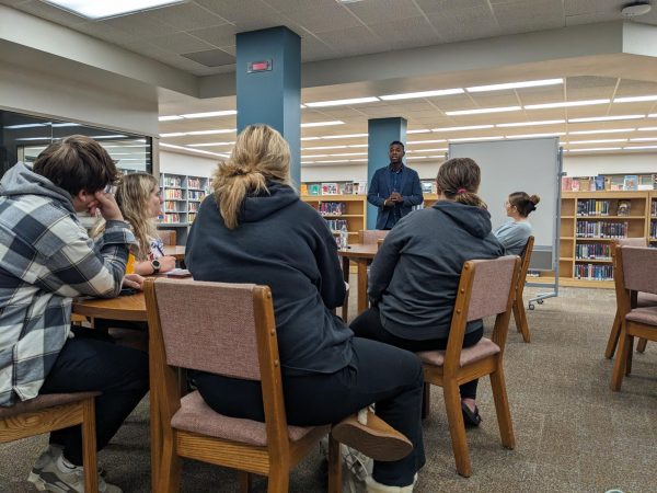 Why Not in Action. Business teacher Ricardo Pierre Louis talks to members as a guest speaker. He talked to them about spending and making money. Vukelich said, “These life skills are very much needed and help us get prepared for the life ahead of us.”