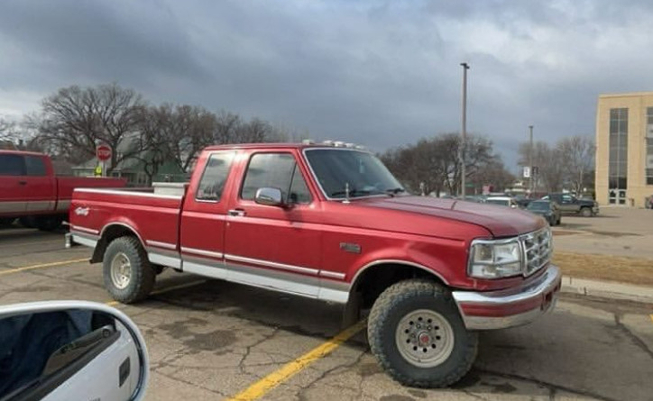 Parking taking up three spots. Parking like this might save a spot for your friend, but it will end up with you getting a ticket.